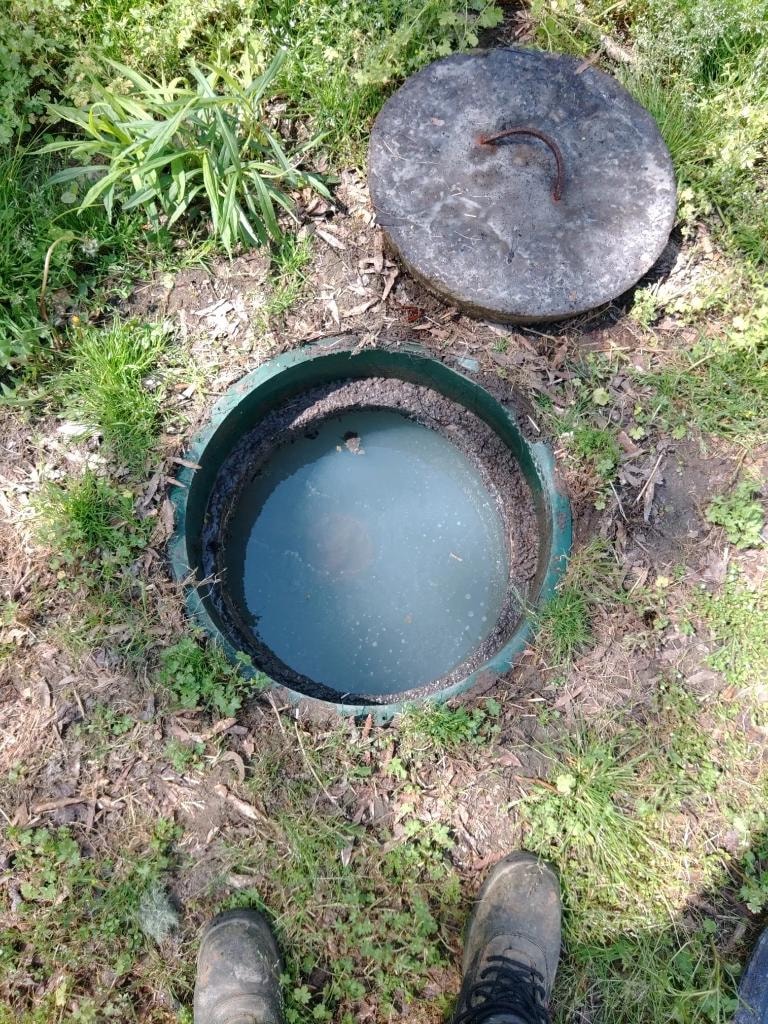 Water level before cleaning the filter. The water level here is high because the filter is stopped up and water cannot flow through.
